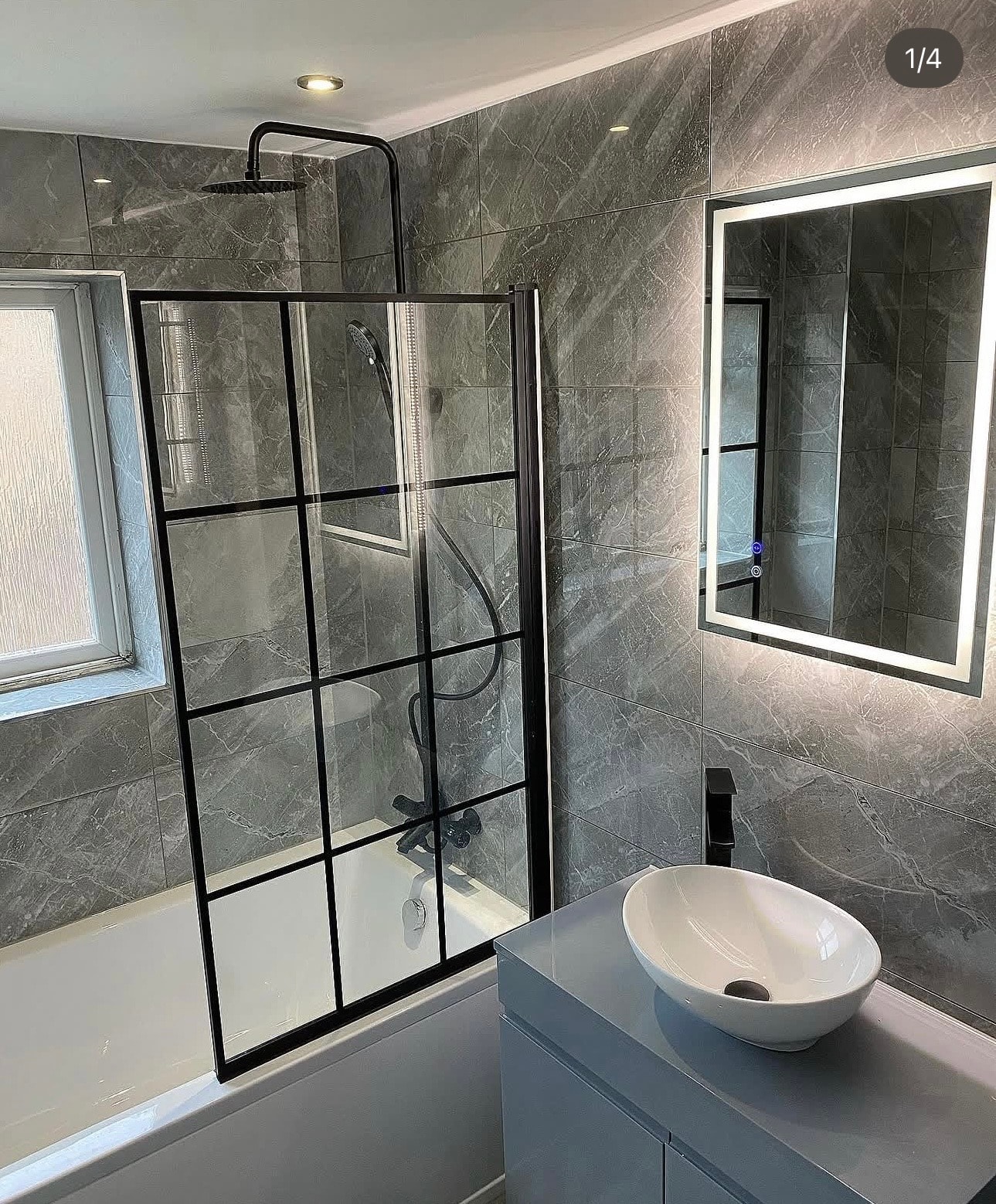 Grey marble bathroom with black grid bath screen, vessel basin and LED mirror