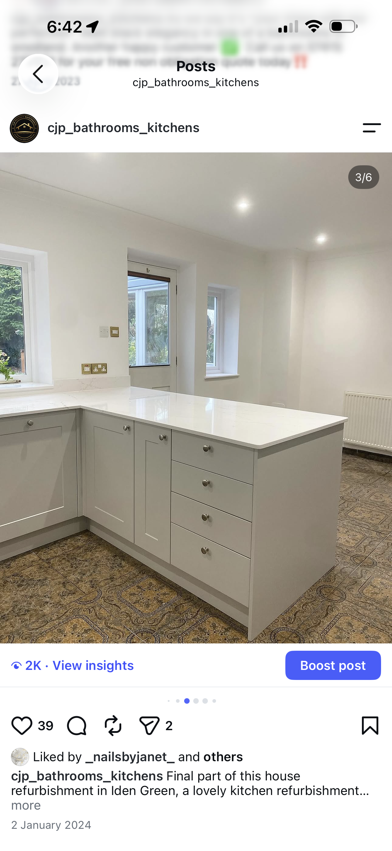 Grey shaker kitchen island with deep drawer stack and white quartz worktop, garden door beyond