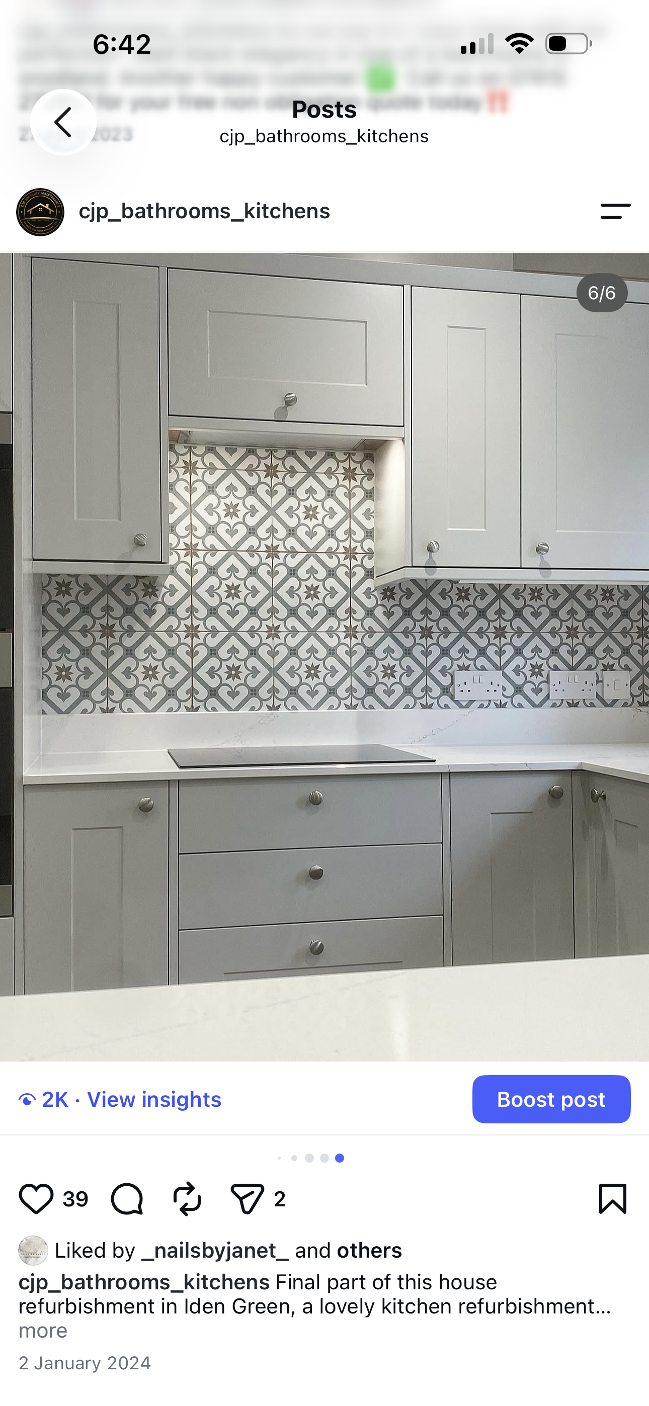 Grey shaker kitchen with decorative patterned tile splashback, induction hob and white quartz worktop