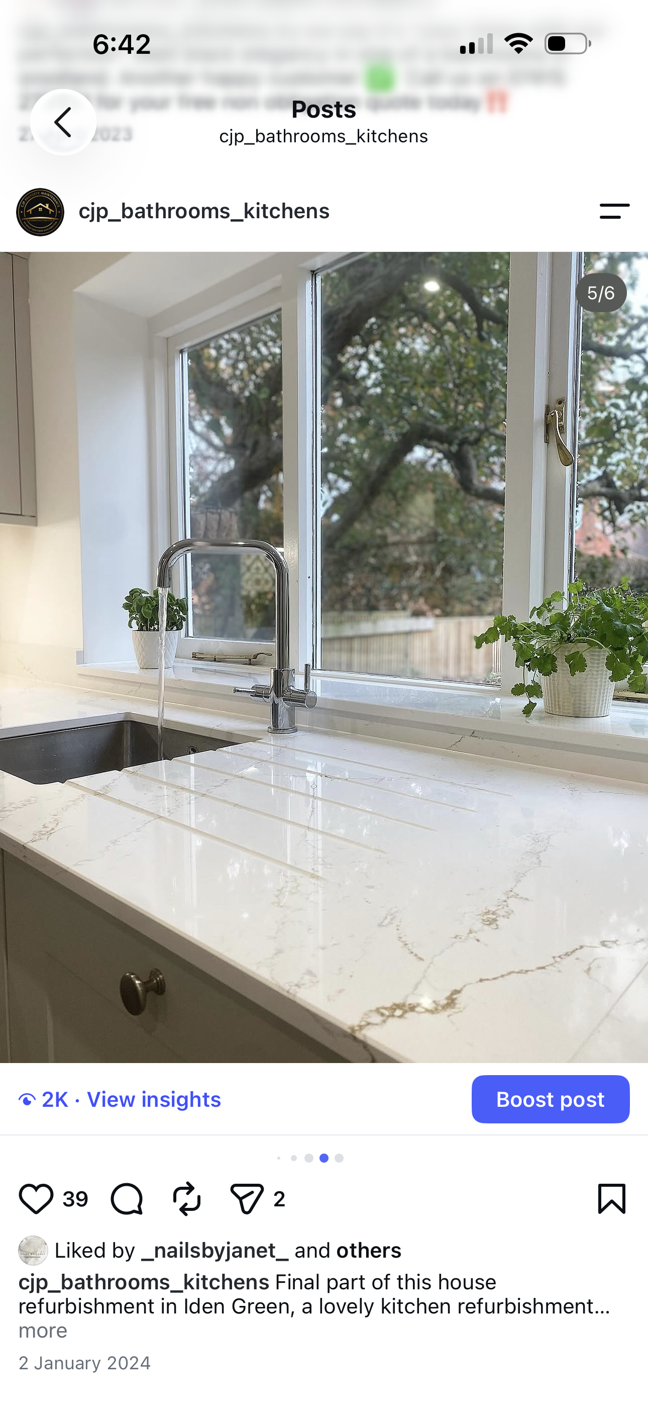 Grey shaker kitchen with white marble-effect quartz worktop, undermount sink and chrome pull-out tap