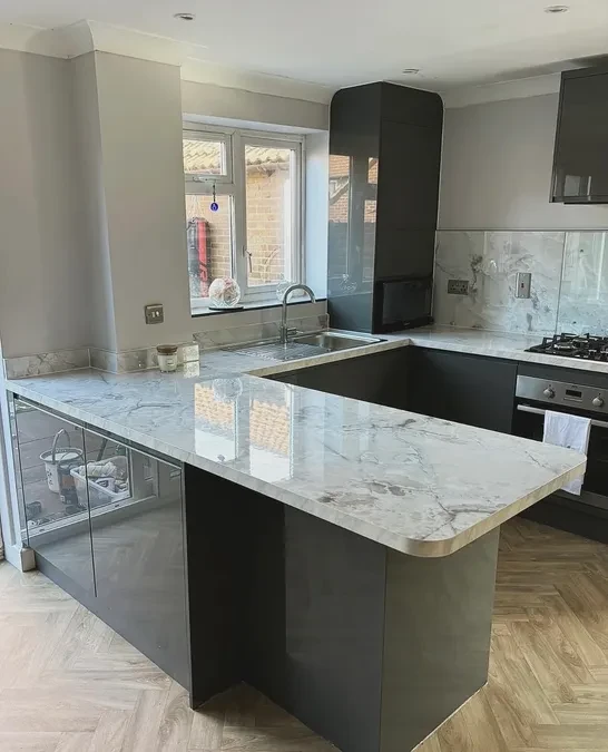 Dark gloss kitchen with marble worktops